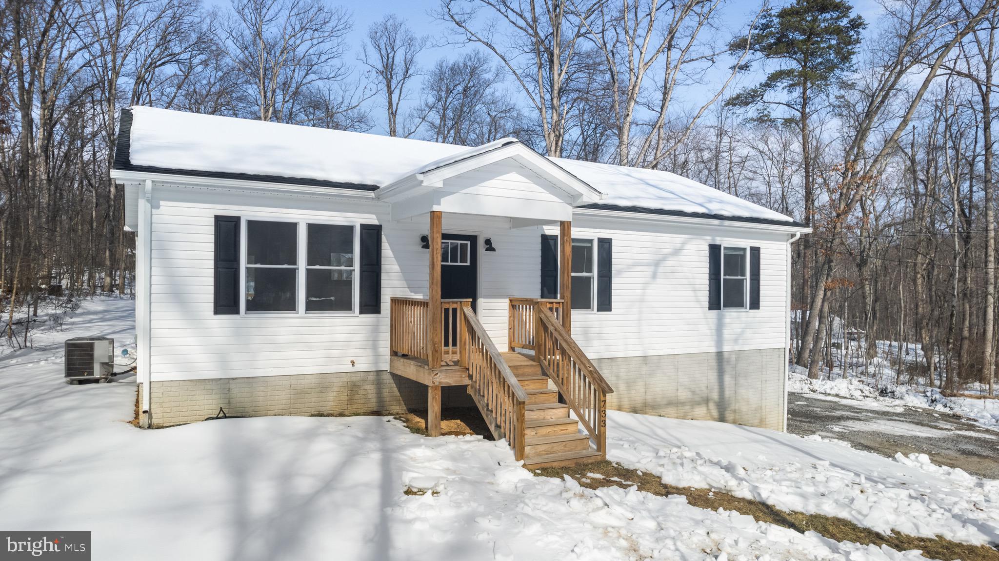 733 Red Bird Lane Harpers Ferry, WV 25425 - Photo 2 of 29 a view of a white house with a large tree and wooden fence