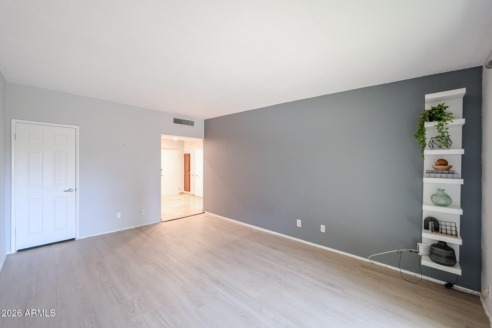 357 East Thomas Road, Unit A208 Phoenix, AZ 85012 - Photo 2 of 36 a view of an empty room with a window and wooden floor