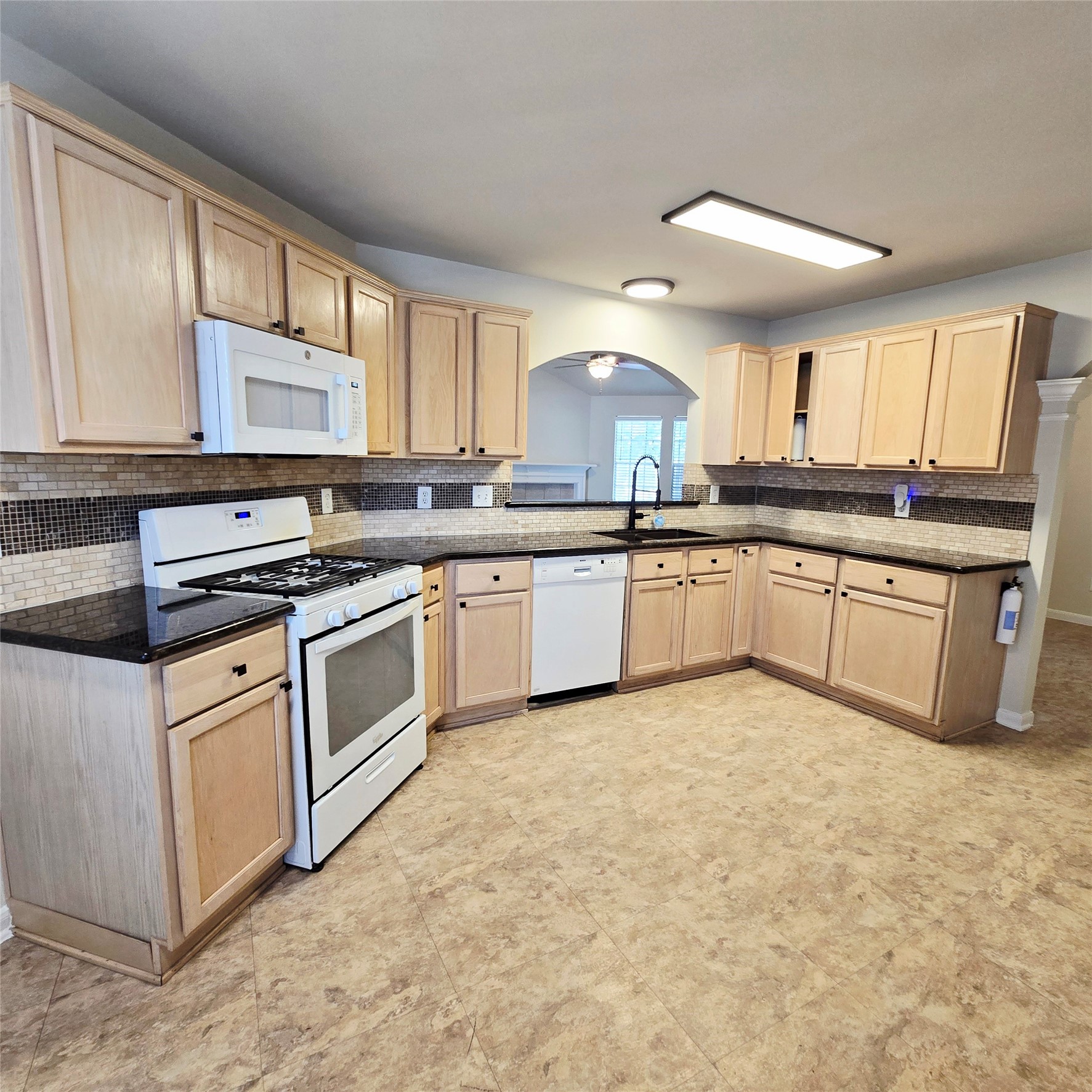 6411 Slate Stone Street Houston, TX 77084 - Photo 18 of 38 Bright, spacious kitchen with gas range, microwave, dishwasher, double sink, and fridge.