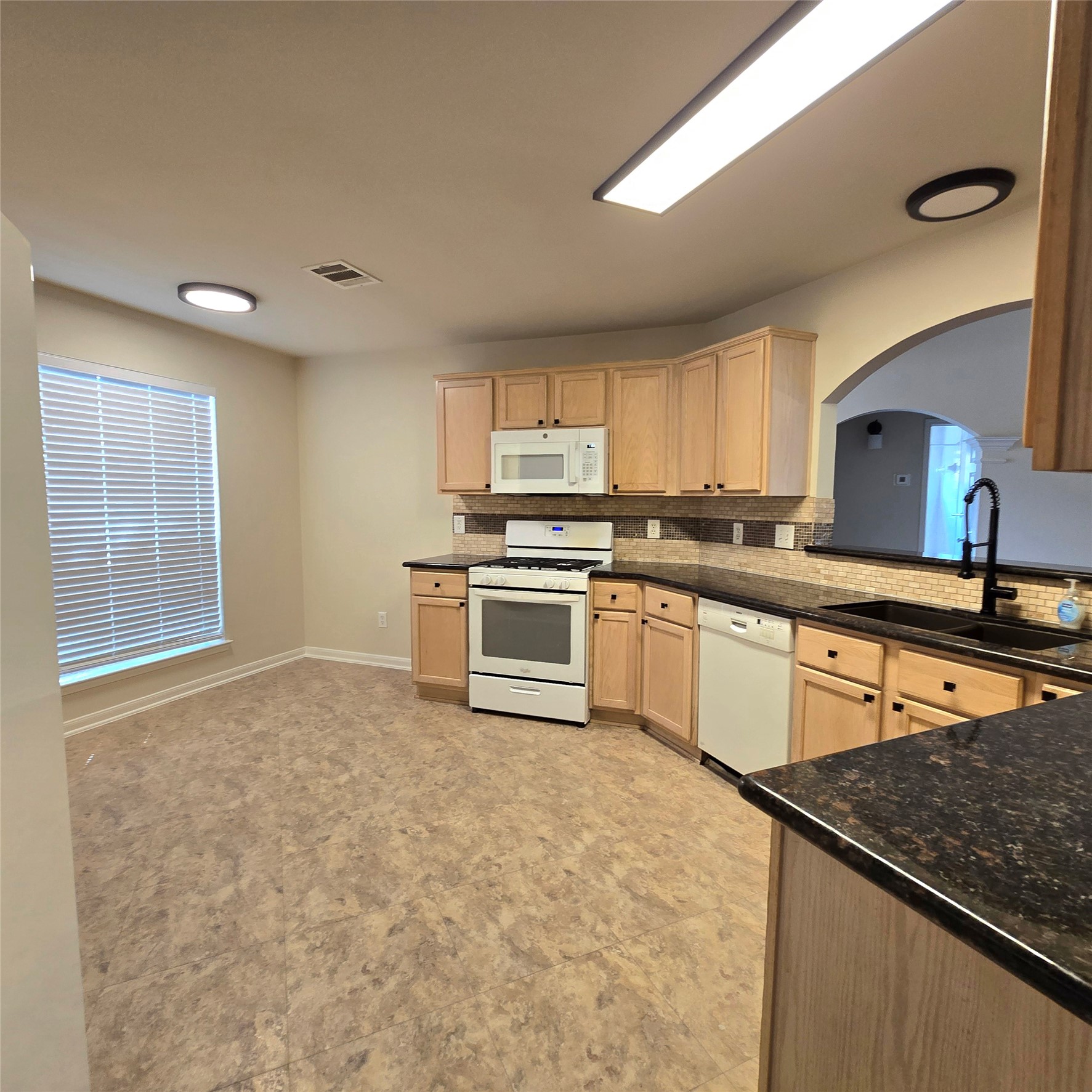 6411 Slate Stone Street Houston, TX 77084 - Photo 19 of 38 Airy and bright kitchen with a large window and a convenient pass-through to the family room.