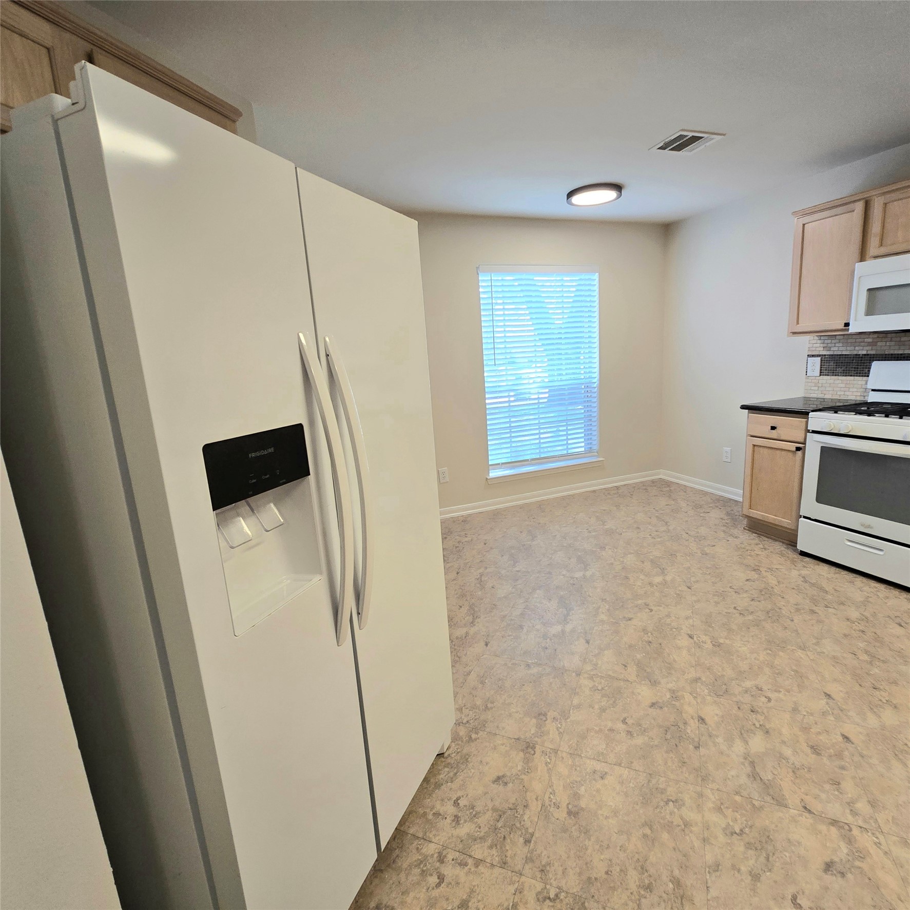 6411 Slate Stone Street Houston, TX 77084 - Photo 22 of 38 Fridge with ice maker and water dispenser.