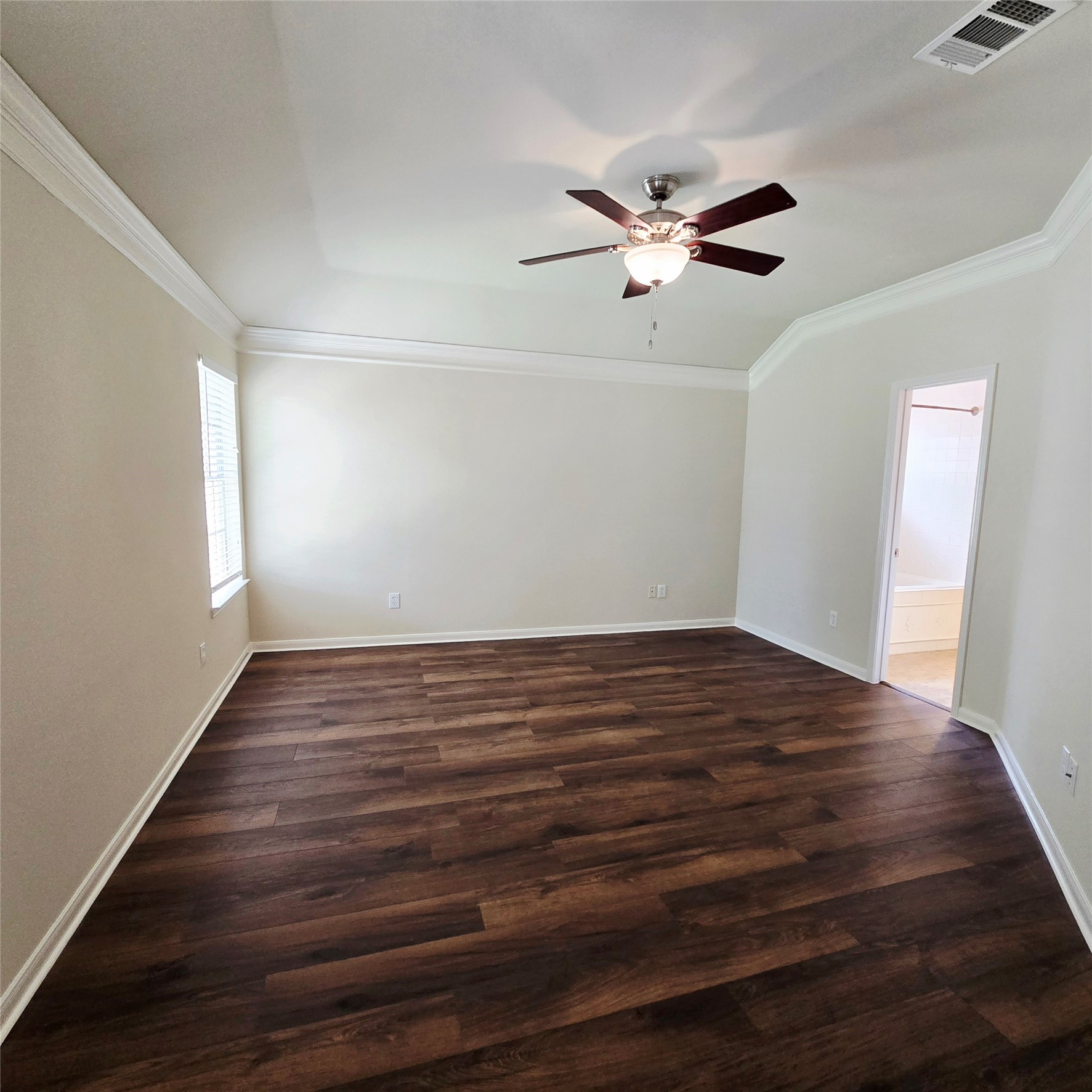 6411 Slate Stone Street Houston, TX 77084 - Photo 6 of 38 Primary bedroom featuring elegant wood floors, a ceiling fan, and abundant natural light.