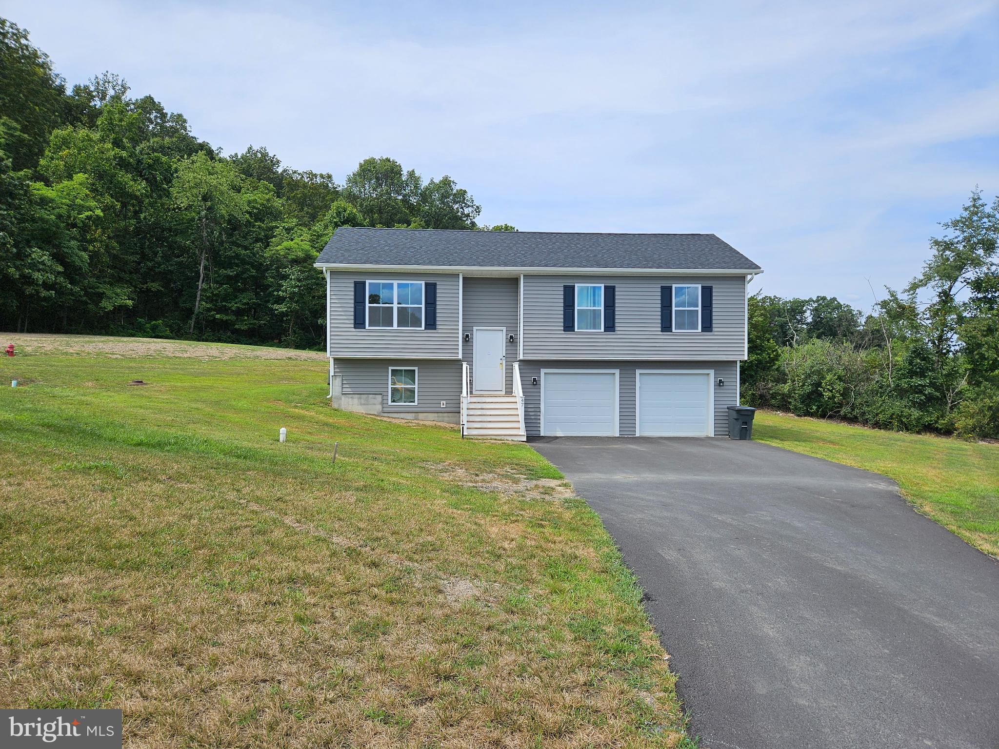 47 Bobbi Court Berkeley Springs, WV 25411 - Photo 2 of 22 a view of a big house with a big yard and large trees