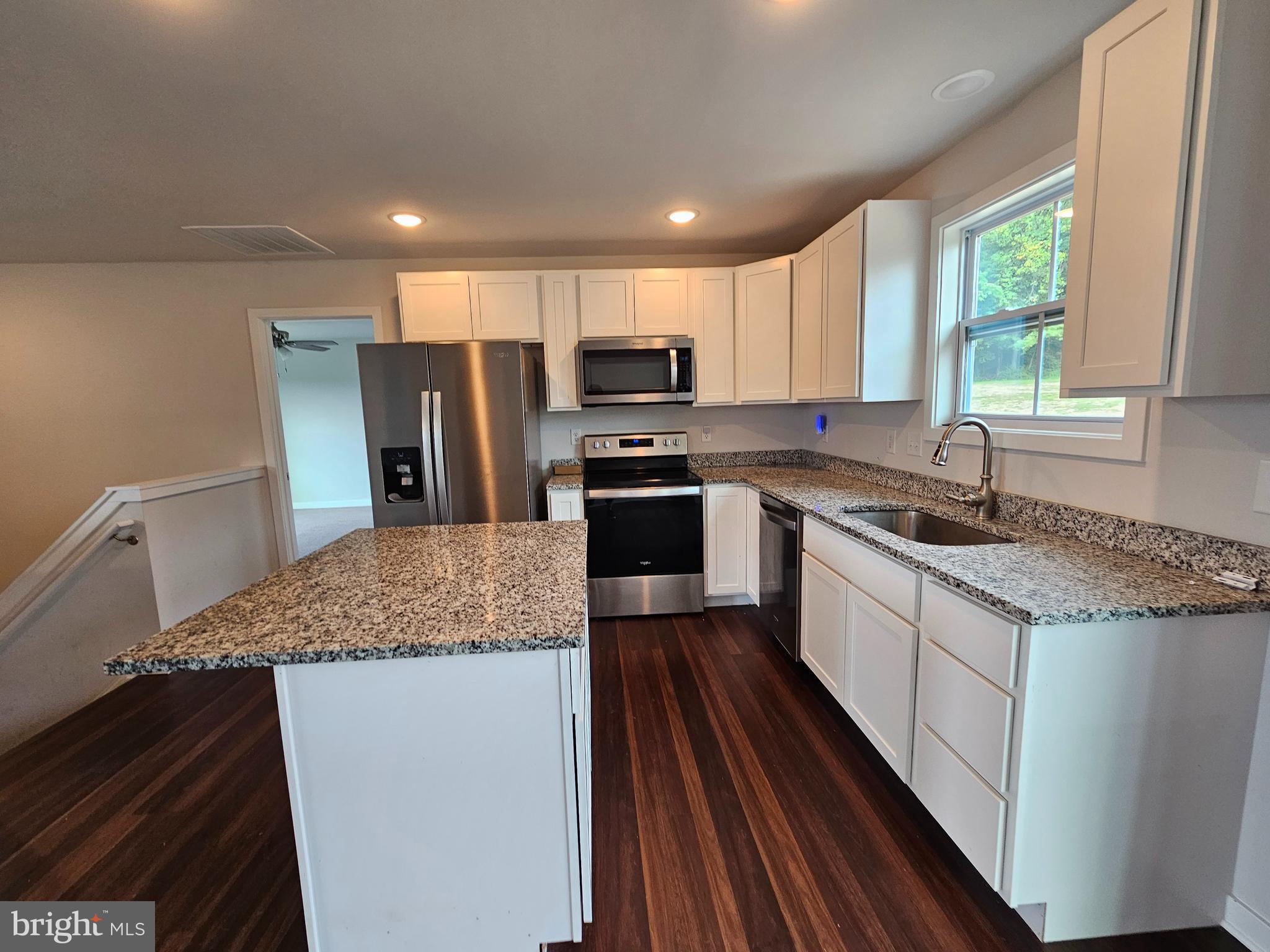 47 Bobbi Court Berkeley Springs, WV 25411 - Photo 5 of 22 a kitchen with stainless steel appliances granite countertop a stove a sink and a refrigerator