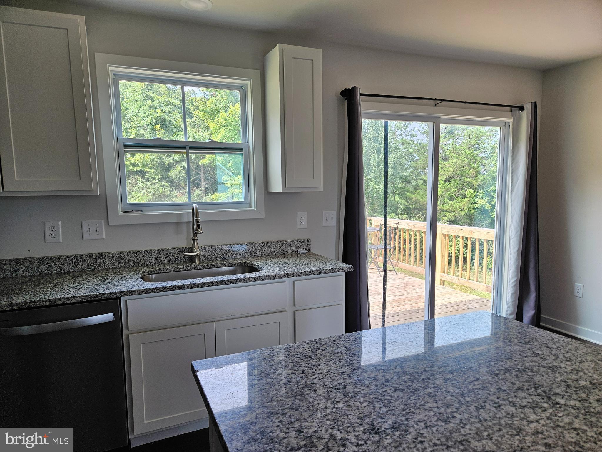 47 Bobbi Court Berkeley Springs, WV 25411 - Photo 7 of 22 a kitchen with stainless steel appliances granite countertop sink stove and refrigerator