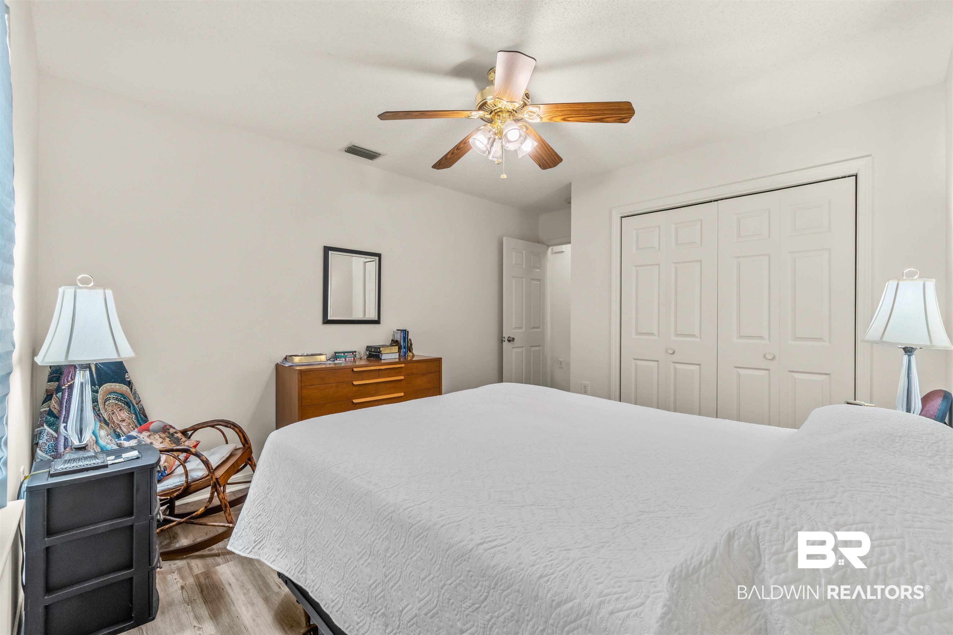 35893 Pine Road South Stapleton, AL 36578 - Photo 20 of 31 Bedroom featuring wood-finish flooring, a ceiling fan, and double bi-fold closet doors