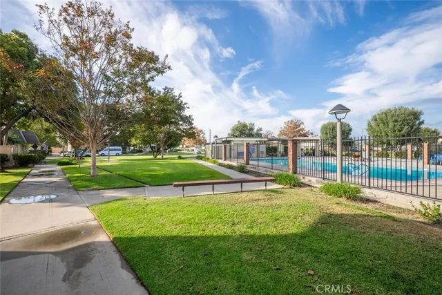 a view of a house with a big yard and potted plants