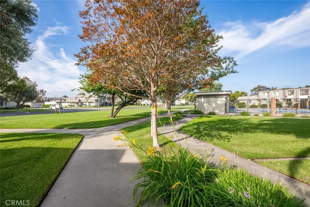 a view of yard with swimming pool and green space
