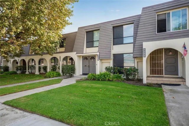 a view of a brick house with a yard