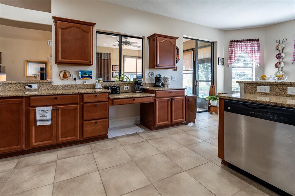 16222 Southwest 14th Avenue Road Ocala, FL 34473 - Photo 15 of 61 a kitchen with stainless steel appliances granite countertop a stove sink and cabinets