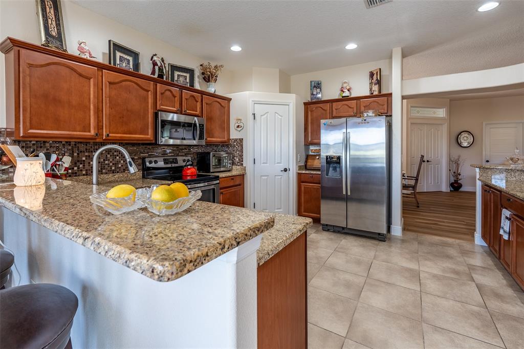 16222 Southwest 14th Avenue Road Ocala, FL 34473 - Photo 17 of 61 a kitchen with sink refrigerator and cabinets
