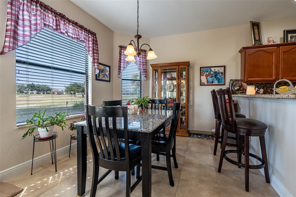 16222 Southwest 14th Avenue Road Ocala, FL 34473 - Photo 20 of 61 a view of a dining room with furniture and a chandelier