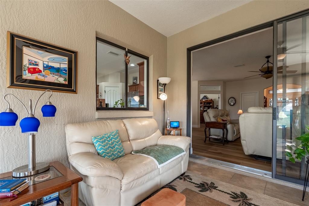 16222 Southwest 14th Avenue Road Ocala, FL 34473 - Photo 22 of 61 a living room with furniture and a flat screen tv