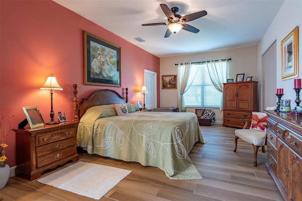 16222 Southwest 14th Avenue Road Ocala, FL 34473 - Photo 26 of 61 a bedroom with a bed furniture and a flat screen tv