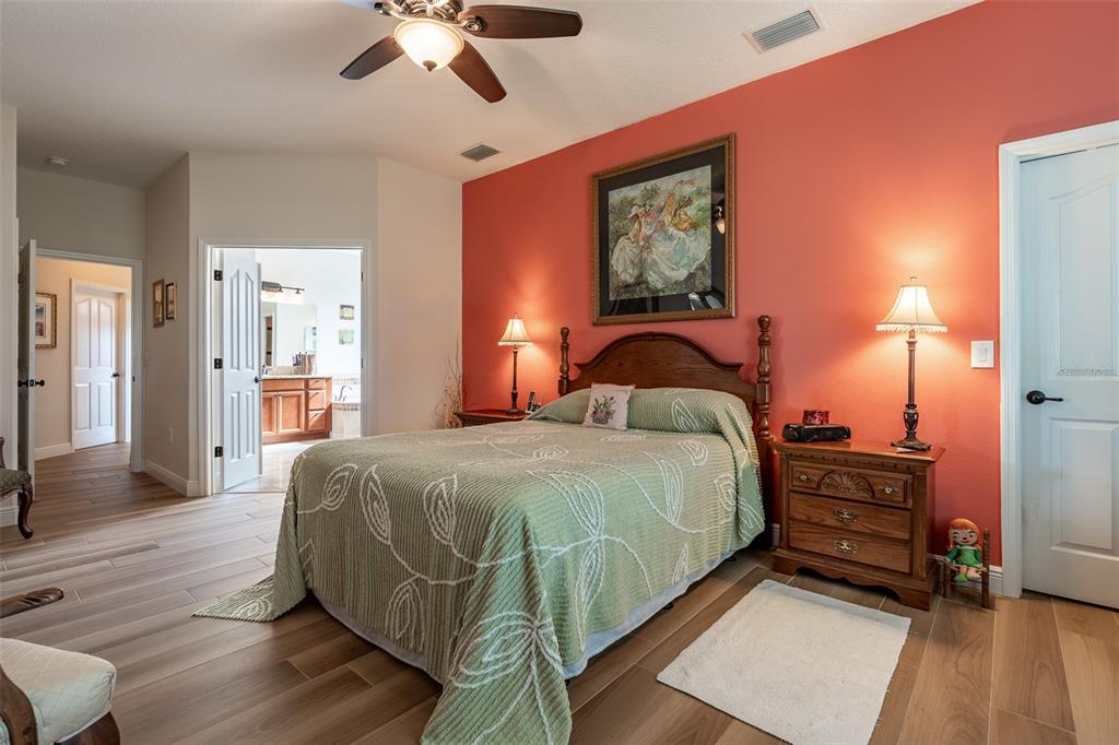 16222 Southwest 14th Avenue Road Ocala, FL 34473 - Photo 27 of 61 a bedroom with a bed and wooden floor