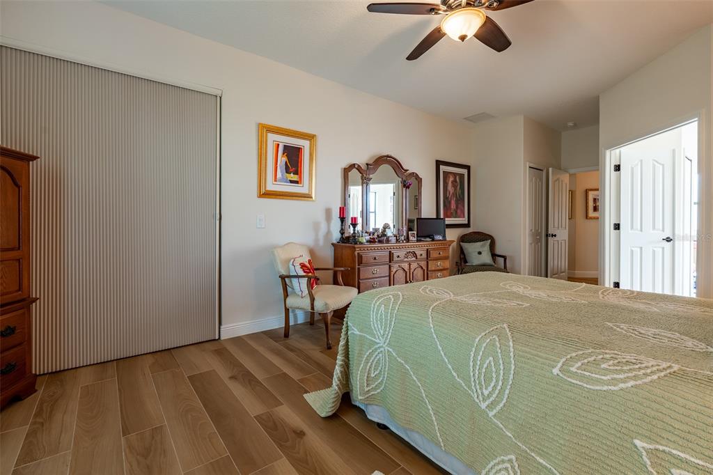16222 Southwest 14th Avenue Road Ocala, FL 34473 - Photo 28 of 61 a bed room with a bed and a chandelier