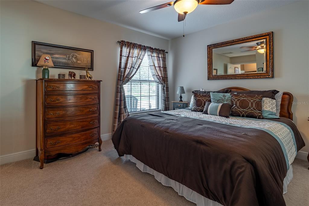 16222 Southwest 14th Avenue Road Ocala, FL 34473 - Photo 35 of 61 a bedroom with a bed and a chandelier