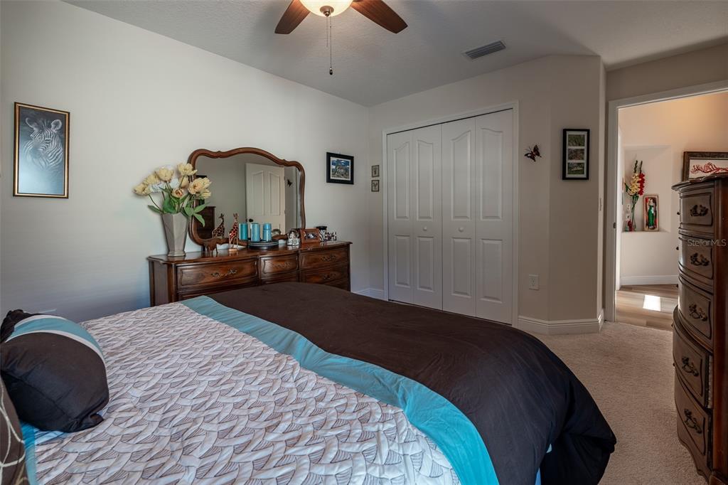 16222 Southwest 14th Avenue Road Ocala, FL 34473 - Photo 36 of 61 a bedroom with a bed and a chandelier