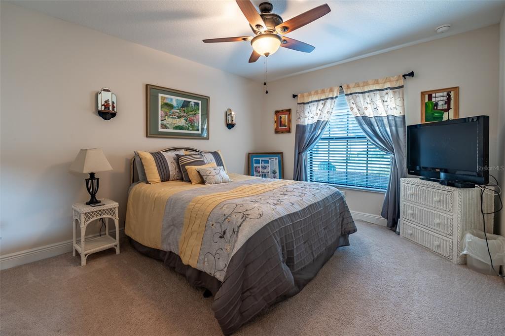 16222 Southwest 14th Avenue Road Ocala, FL 34473 - Photo 40 of 61 a spacious bedroom with a bed and a flat screen tv