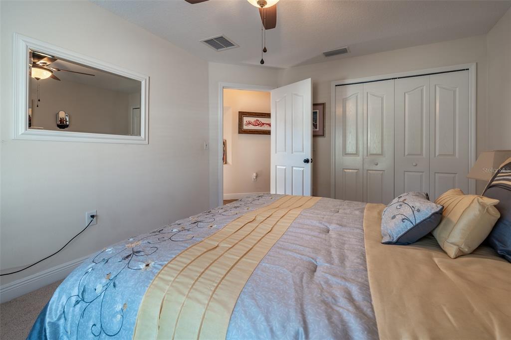 16222 Southwest 14th Avenue Road Ocala, FL 34473 - Photo 41 of 61 a bedroom with a bed and a painting on the wall