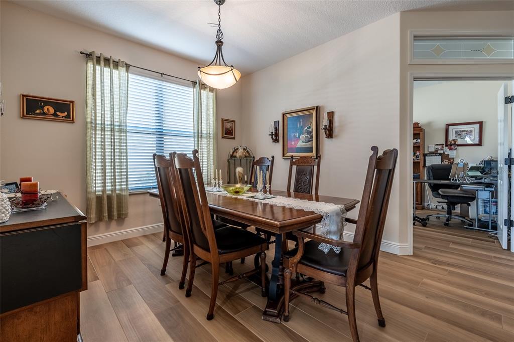 16222 Southwest 14th Avenue Road Ocala, FL 34473 - Photo 9 of 61 a view of a dining room with furniture window and wooden floor