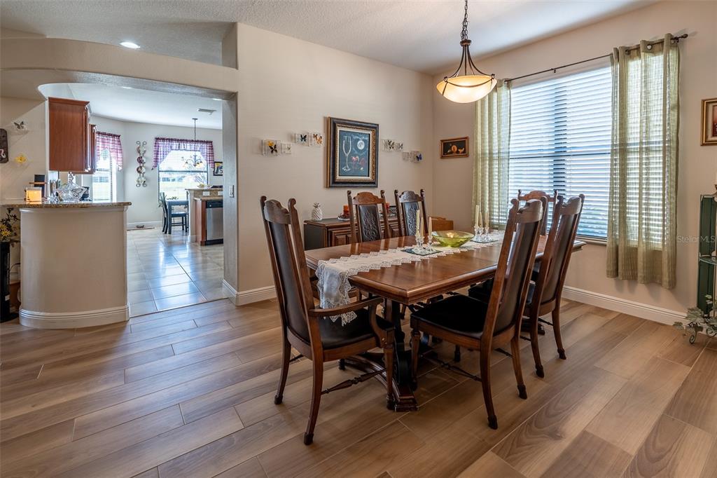 16222 Southwest 14th Avenue Road Ocala, FL 34473 - Photo 10 of 61 a view of a dining room with furniture window and wooden floor
