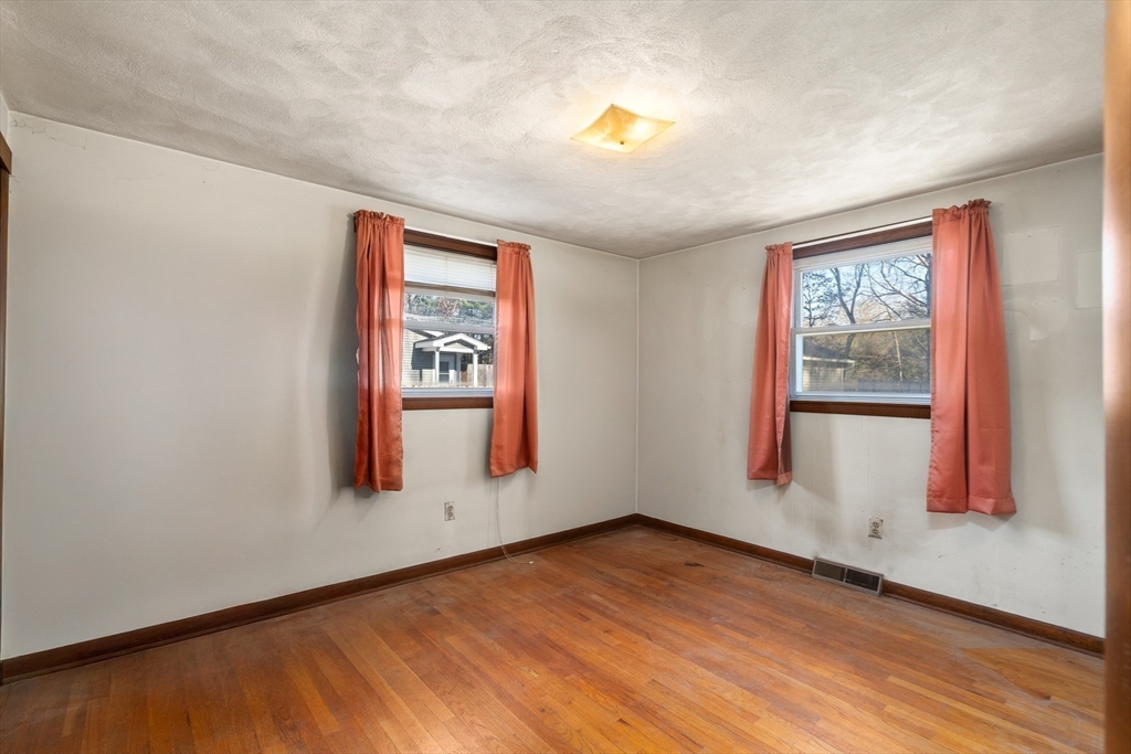 331 Grand Valley Road Springfield, MA 01128 - Photo 20 of 37 an empty room with wooden floor and windows
