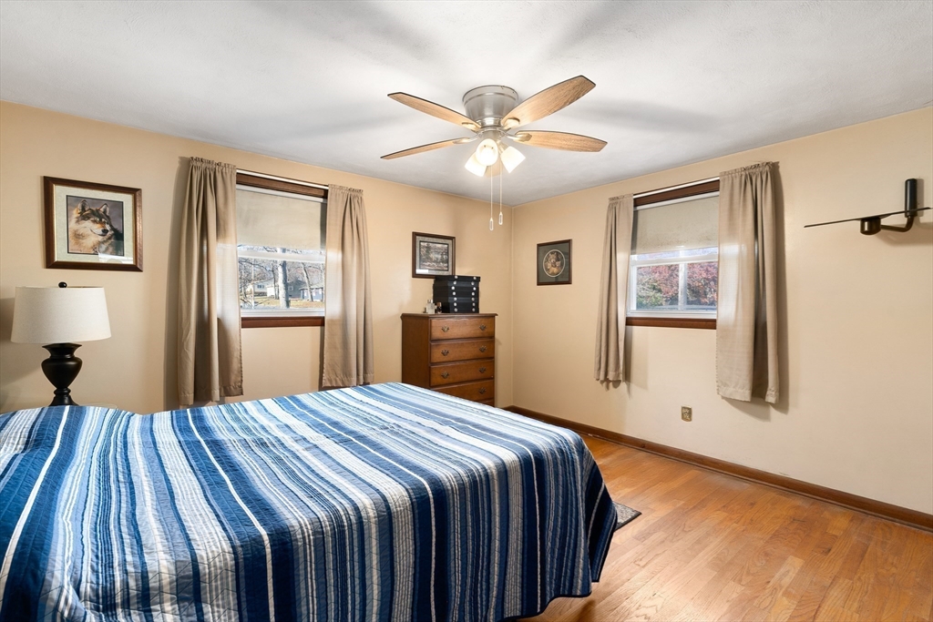 331 Grand Valley Road Springfield, MA 01128 - Photo 22 of 37 a bedroom with a large bed and a chandelier