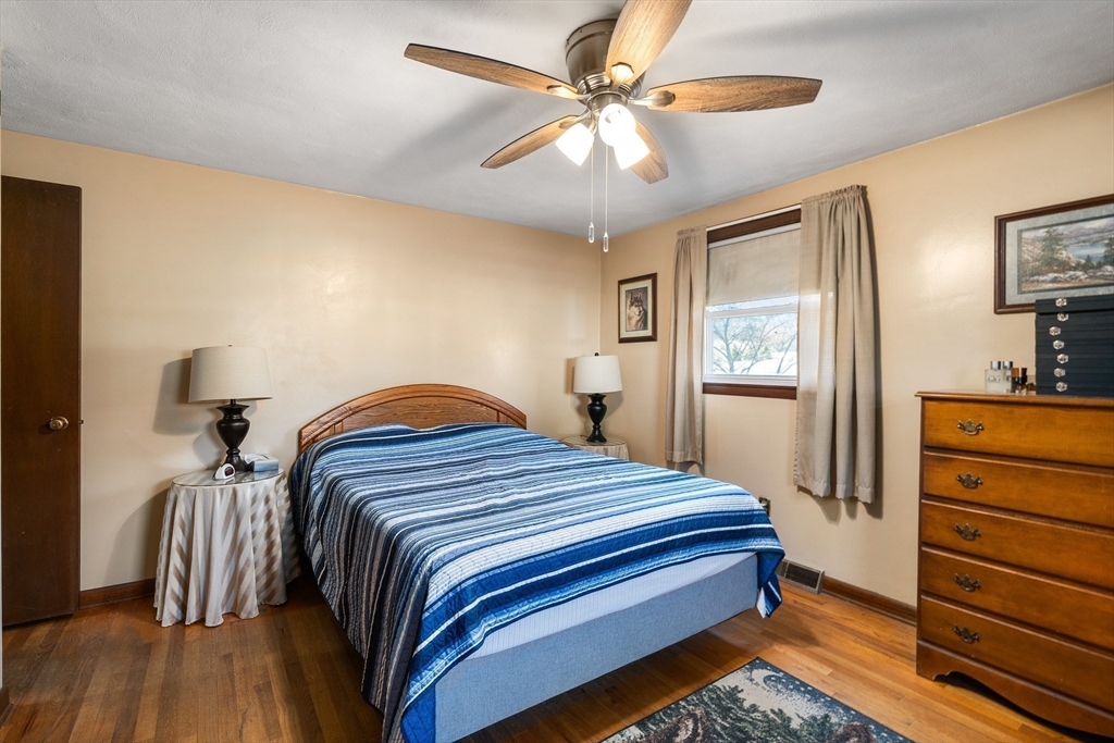 331 Grand Valley Road Springfield, MA 01128 - Photo 23 of 37 a bedroom with a bed and a chandelier