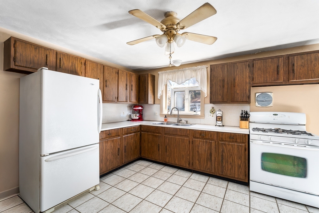 331 Grand Valley Road Springfield, MA 01128 - Photo 10 of 37 a kitchen with a stove a sink and white refrigerator