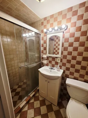 a bathroom with a sink and mirror with toilet