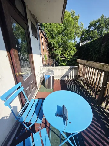 a view of a chairs and table in the balcony