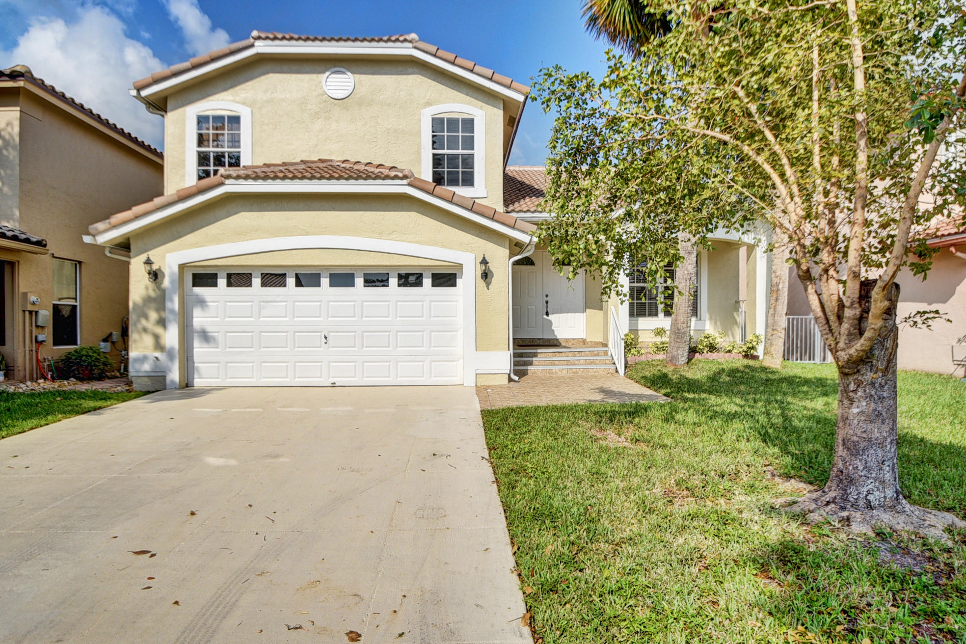 18098 Clear Brook Circle Boca Raton, FL 33498 - Photo 1 of 48 a front view of a house with a yard and trees