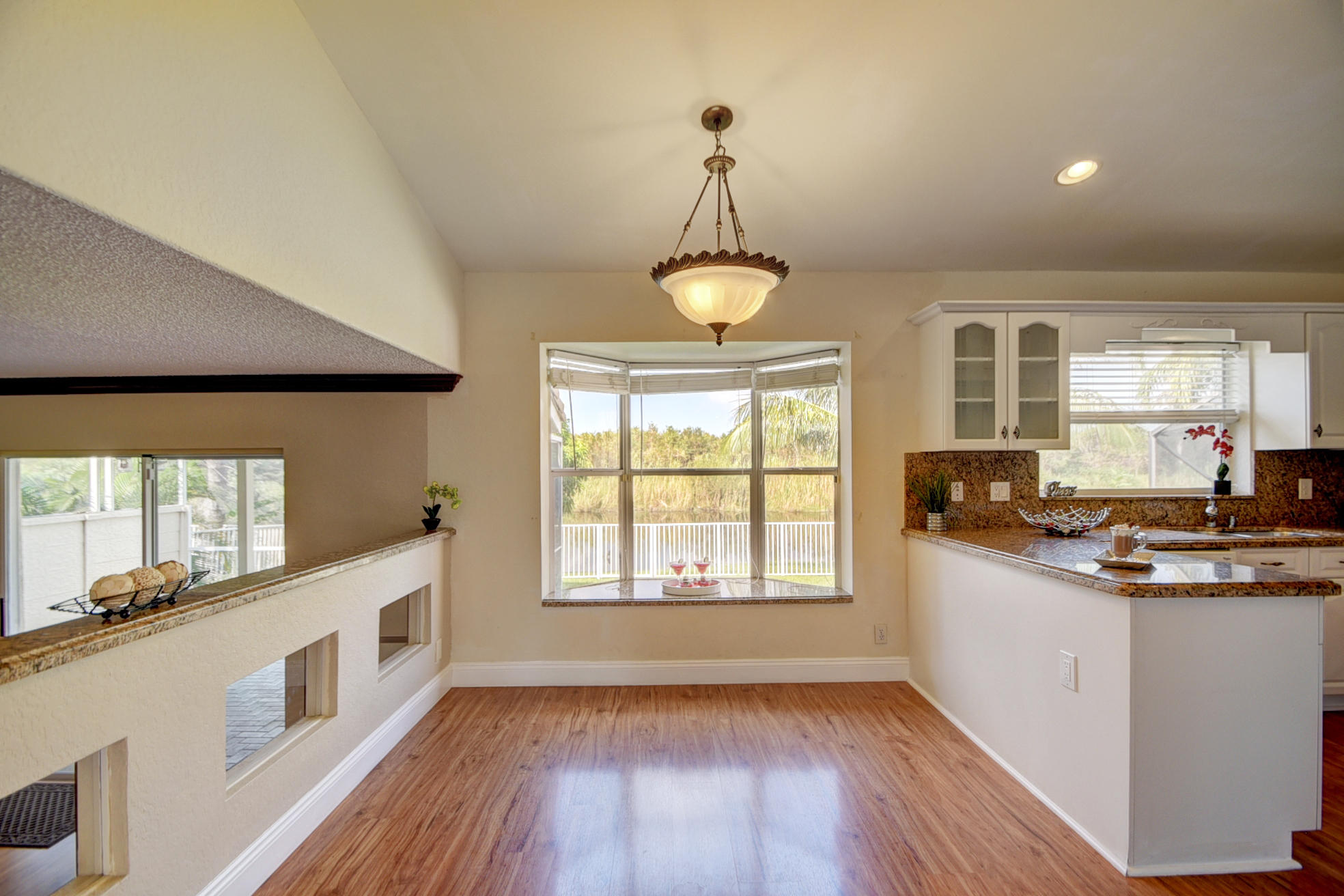 18098 Clear Brook Circle Boca Raton, FL 33498 - Photo 15 of 48 a kitchen with stainless steel appliances a stove a sink a window and wooden floor
