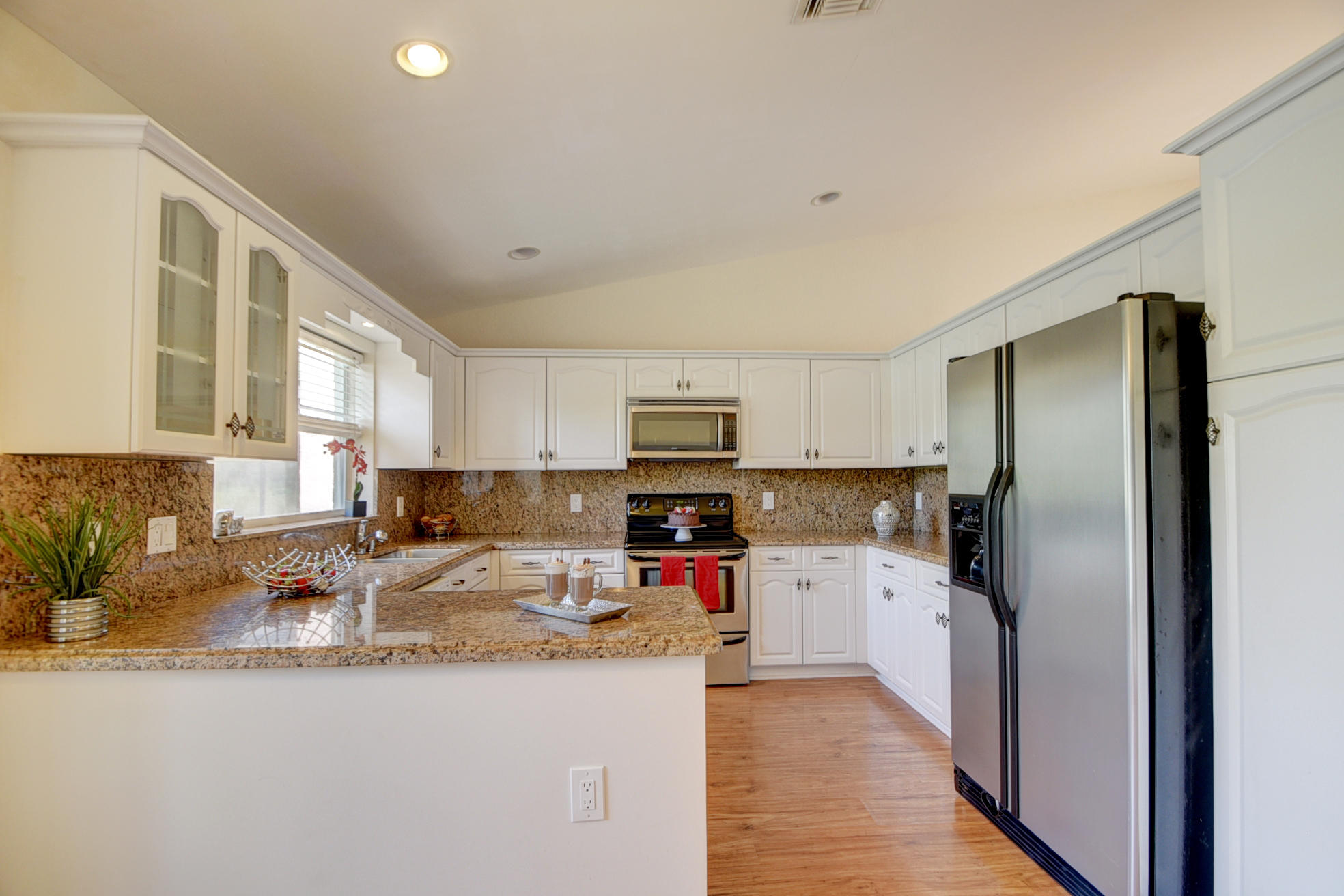 18098 Clear Brook Circle Boca Raton, FL 33498 - Photo 18 of 48 a kitchen with granite countertop a refrigerator and a sink