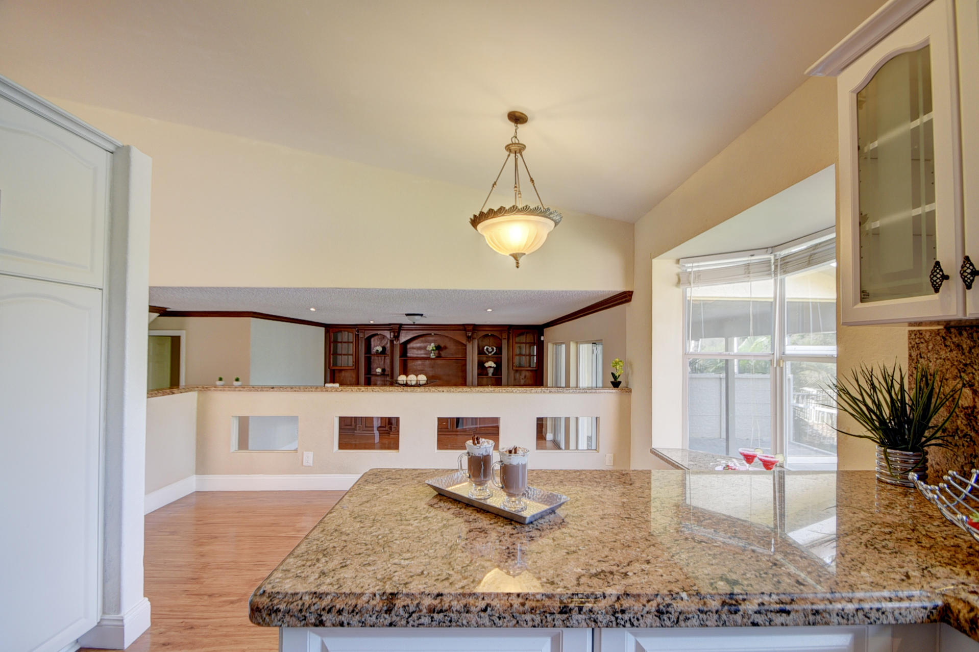 18098 Clear Brook Circle Boca Raton, FL 33498 - Photo 21 of 48 a view of a kitchen with a dining table and chairs