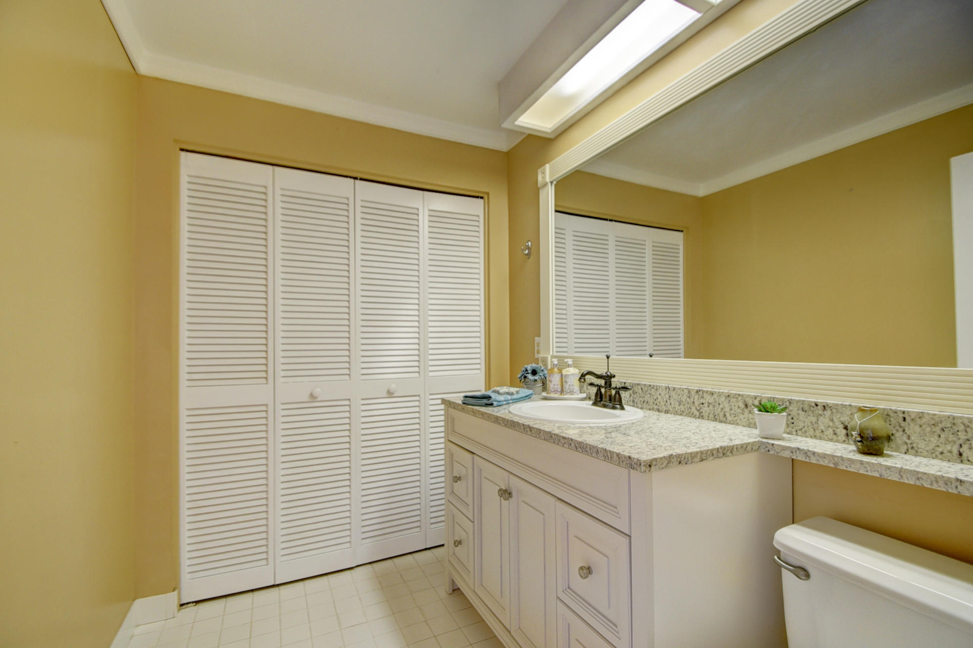 18098 Clear Brook Circle Boca Raton, FL 33498 - Photo 25 of 48 a bathroom with a granite countertop sink and a mirror