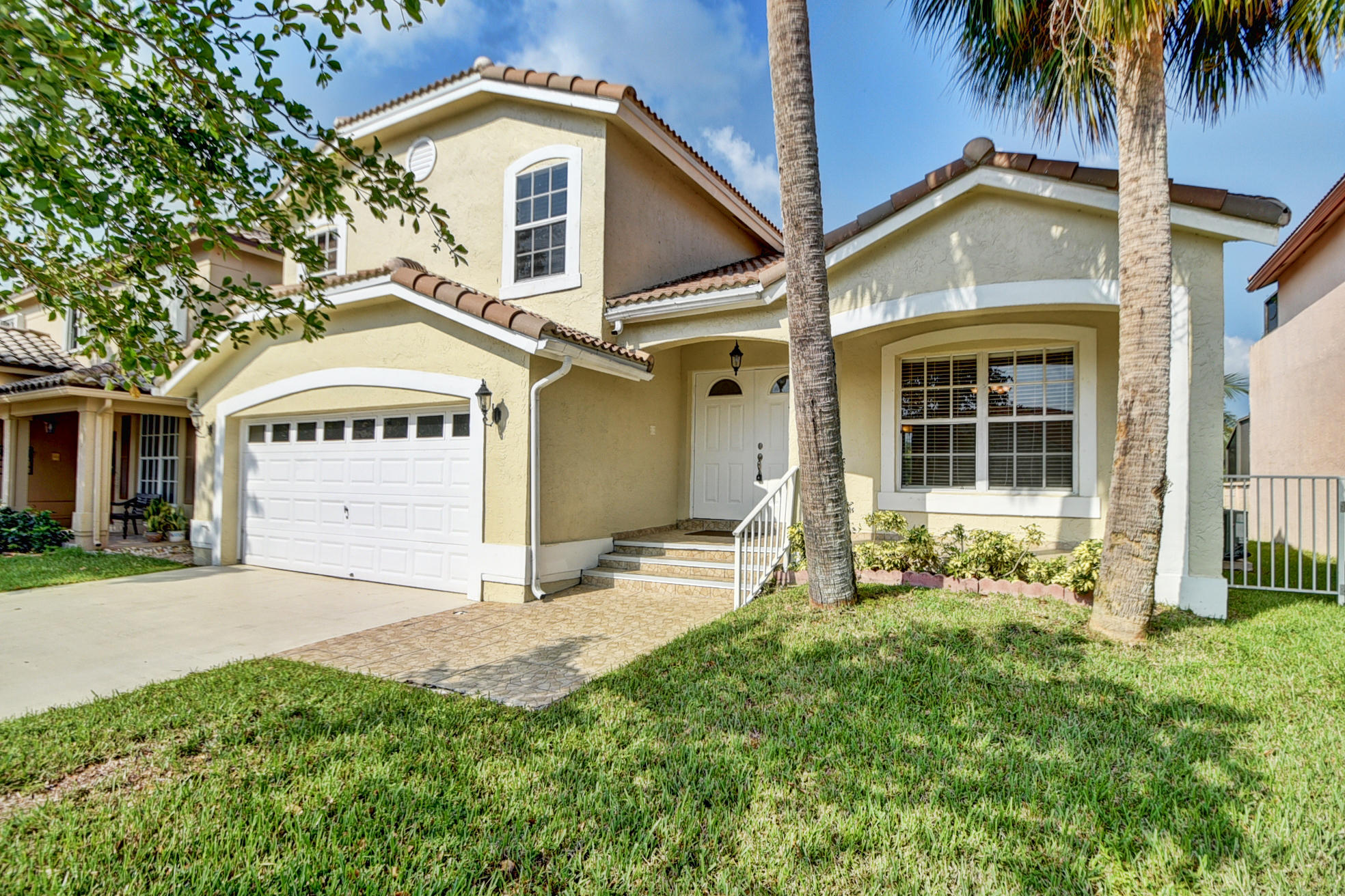 18098 Clear Brook Circle Boca Raton, FL 33498 - Photo 3 of 48 front view of a house with a yard