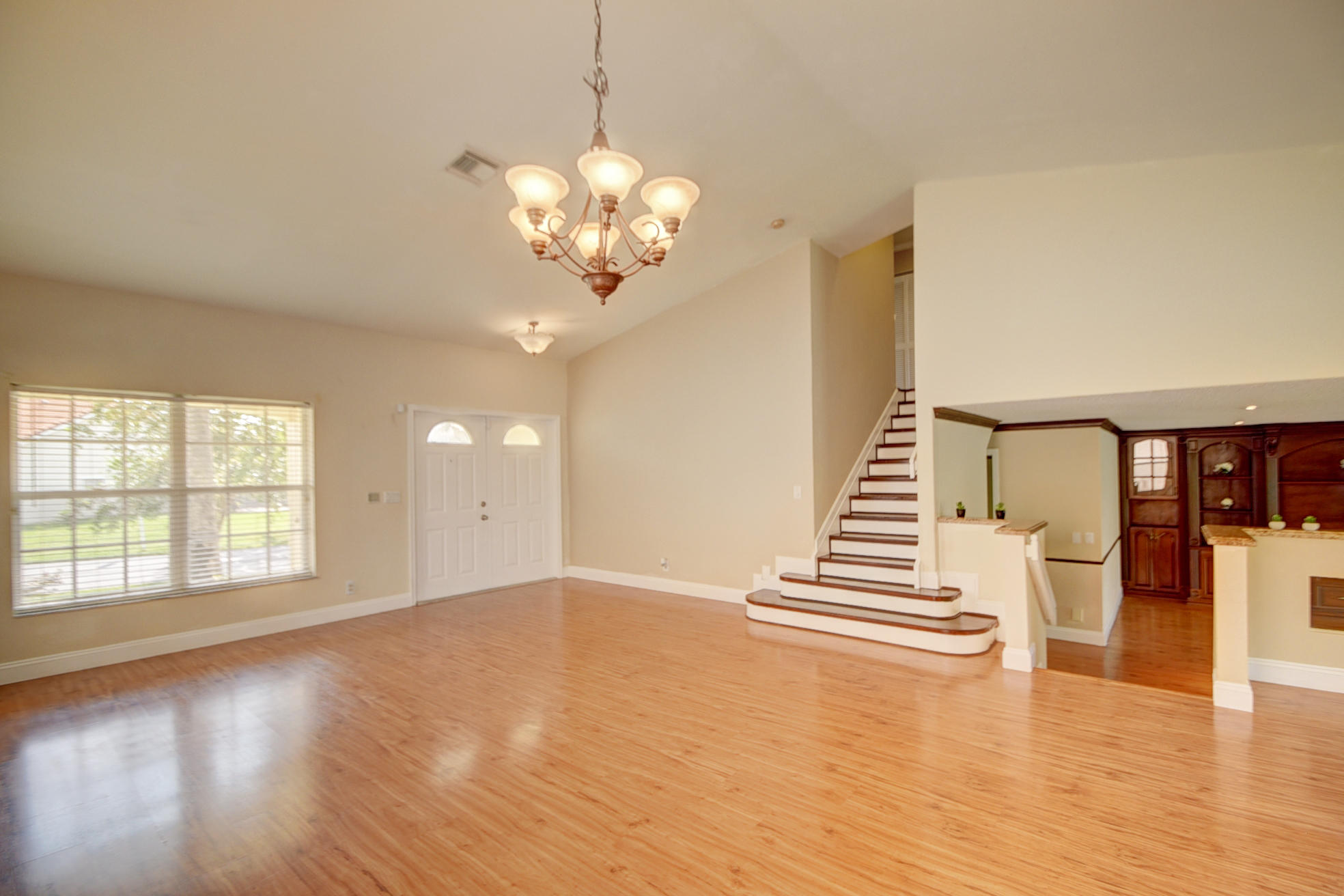 18098 Clear Brook Circle Boca Raton, FL 33498 - Photo 9 of 48 a view of an empty room with wooden floor and fan