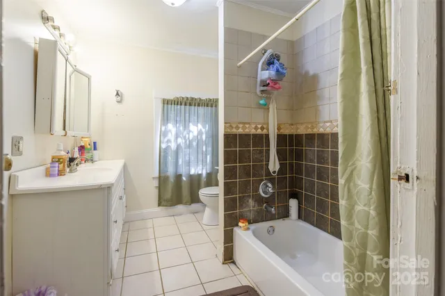 a bathroom with a bathtub sink and mirror