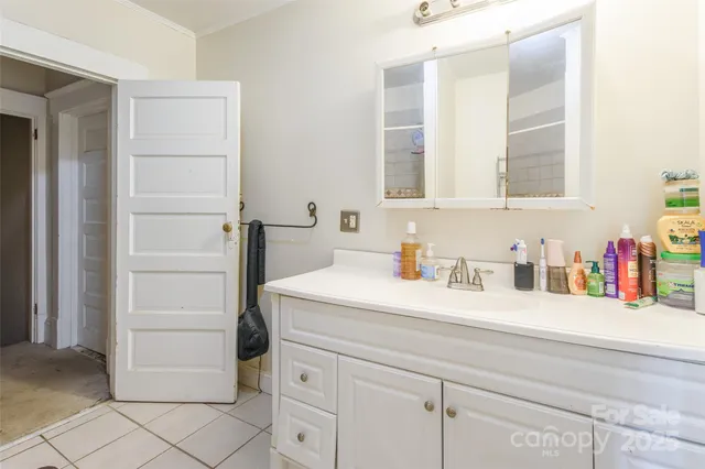 a bathroom with a sink vanity and a mirror