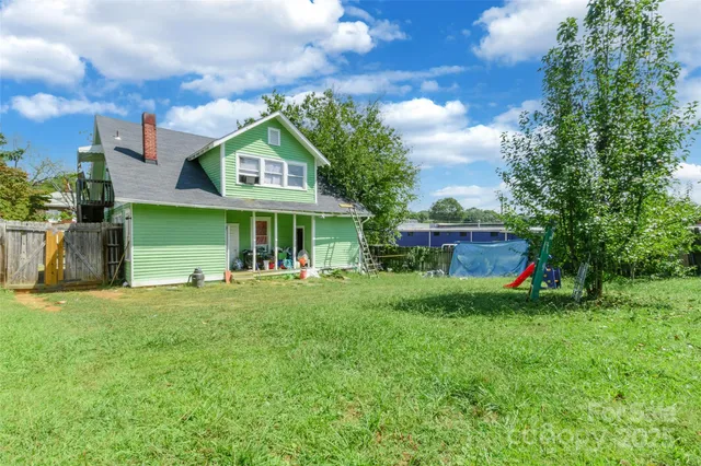 a view of a house with a yard and sitting area