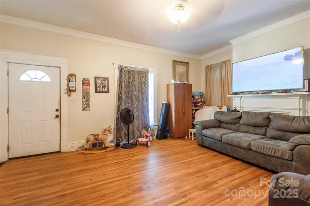 a living room with furniture window and a flat screen tv