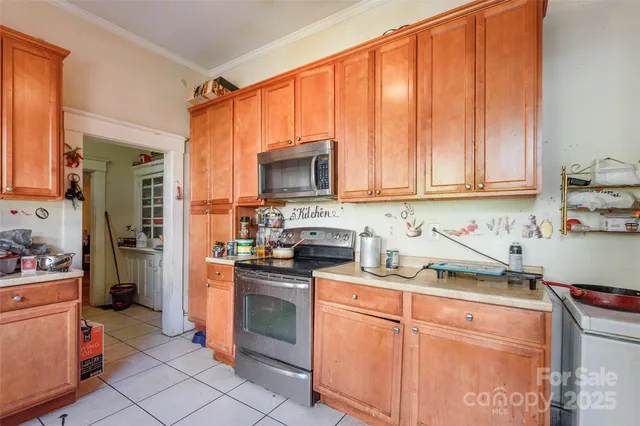 a kitchen with stainless steel appliances granite countertop a stove a sink dishwasher and a microwave oven with cabinets