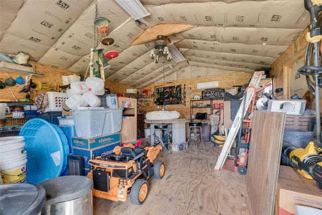 a living room with lots of furniture and clutter