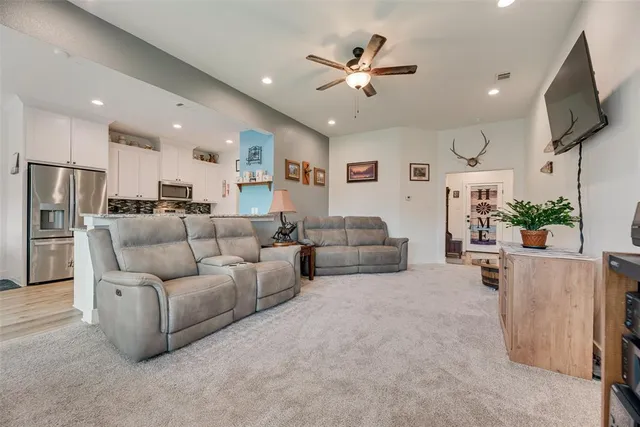 a living room with furniture and a chandelier