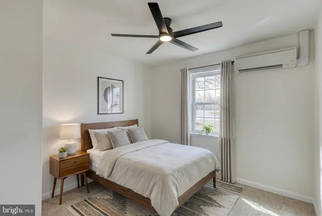 a bedroom with a bed a couch and a window