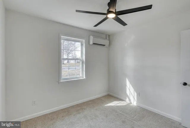 a view of a livingroom with a ceiling fan and window