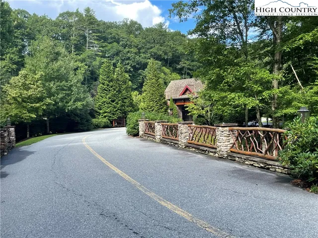 a park view with a bench in a forest