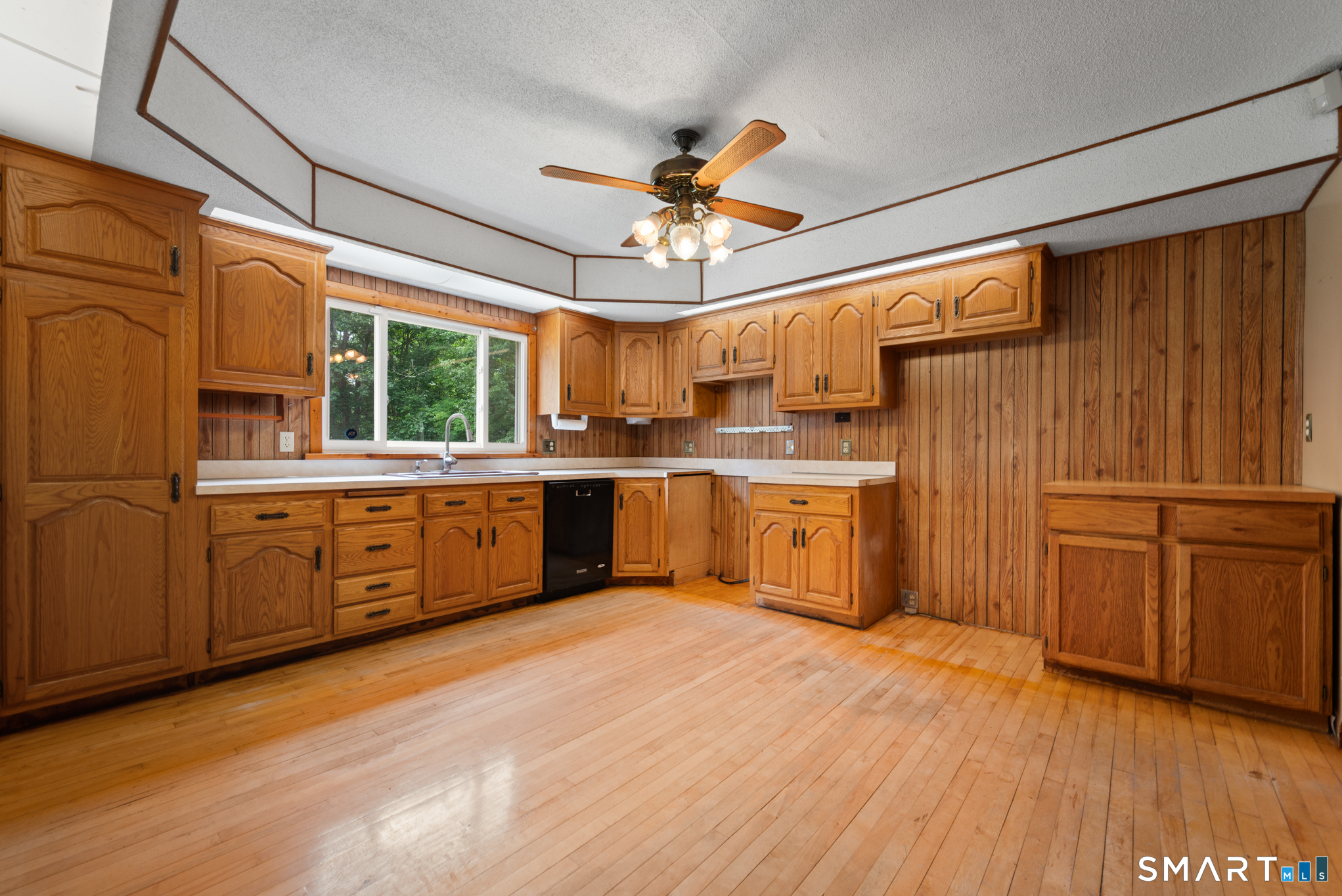 152 Ramstein Road New Hartford, CT 06057 - Photo 2 of 20 a kitchen with stainless steel appliances granite countertop a sink cabinets and wooden floors